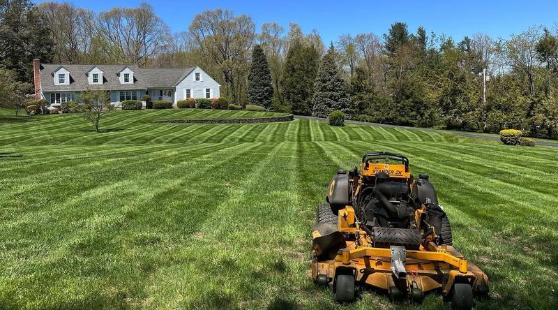 Freshly striped lawn with an Iovanna stand-on mower