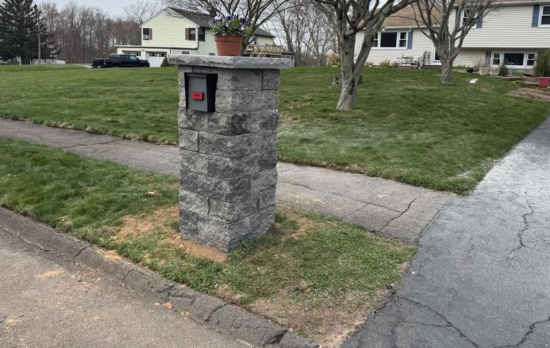 Stone mailbox pillar built by Iovanna beside a driveway